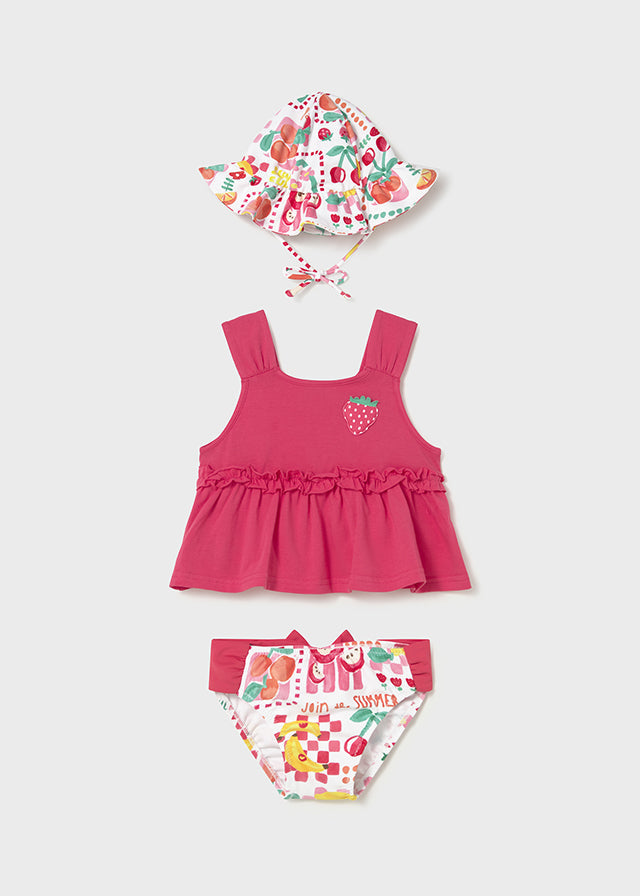 Рожевий купальний комплект для дівчинки з топом на бретелях, плавками з принтом та легкою панамою на зав’язках